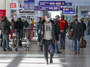 Travellers walk through Pierre Elliott Trudeau International Airport in Montreal Friday December 18, 2020. (John Mahoney / MONTREAL GAZETTE) ORG XMIT: 65517 - 5112