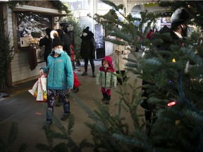 People walk along the Christmas market at Jean-Talon market Dec. 18, 2020.