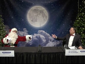 Santa Claus, left, and Premier François Legault speak to children about Santa's Christmas plans on Sunday, Dec. 20, 2020.