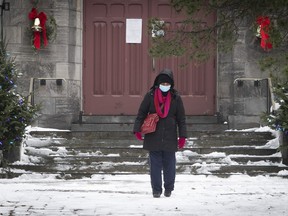 A woman leaves Notre-Dame-des-Neiges church on Dec. 21, 2020.