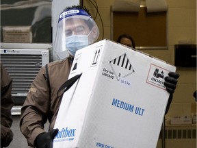 UPS driver Angelo Aranitis, right, delivers the first box of COVID-19 vaccinations at Maimonides on Dec. 14, 2020.