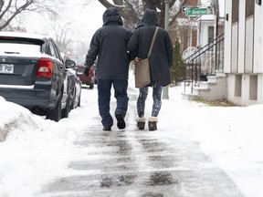 A woman helps an elderly man along an icy sidewalk in LaSalle in 2018. “In some cases, city policies aren’t good enough, and that goes for hilly areas that can get very slippery with just one centimetre of ice,” says pedestrian-rights advocate Dan Lambert.