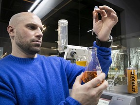 Former Alouettes player Etienne Boulay gets a closer look at  Atypique, a non-alcoholic drink, formulated in the lab at Station Agro-Biotech in St-Hyacinthe.