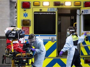 Montreal paramedics transport a senior to a COVID-19 unit in December 2020.