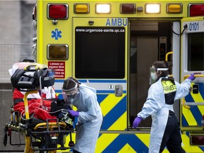 Urgences-santé paramedics transport a patient to the COVID-19 unit of Notre-Dame Hospital on Wednesday, Dec. 30, 2020.