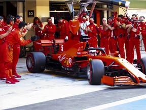The Ferrari team applaud as Sebastian Vettel of Germany driving the Scuderia Ferrari SF1000 leaves the garage for his final race for the team prior to the F1 Grand Prix of Abu Dhabi at Yas Marina Circuit on Sunday, Dec. 13, 2020, in Abu Dhabi, United Arab Emirates.