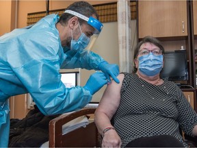 Gloria Lalloux, 78, receives the Pfizer-BioNTech COVID-19 vaccine at the Maimonides Geriatric Centre in Montreal on Monday, Dec. 14, 2020.