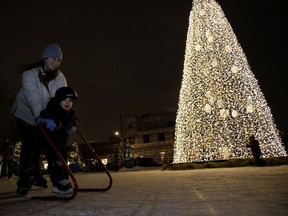 Laurence Allard-Reindeau skates with her 2-year-old son, Harry Cervantes-Allard in a green space turned skating rink in the Pointe-Claire Village, in Montreal on Wednesday, December 23, 2020.
