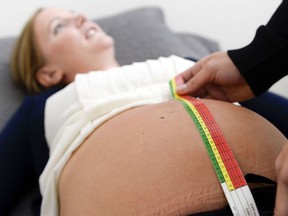 A midwife checks pregnancy progress at a clinic.