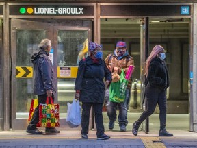Mask-wearing commuters use the Atwater entrance to the Lionel-Groulx métro station Oct. 22, 2020.