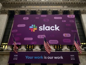 (FILES) In this file photo taken on June 20, 2019, the logo of Slack Technologies Inc. adorns the New York Stock Exchange after the company's public offering. - Salesforce on December 1, 2020, announced a $27.7 billion deal to buy online collaboration firm Slack, giving the business software giant a broader array of tools  as the pandemic fuels a remote work trend.