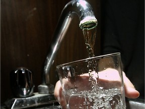 A glass of water being filled from a faucet