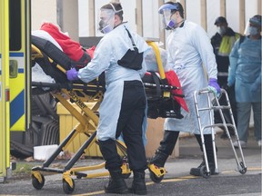 Paramedics transfer a person from Maimonides Geriatric Centre in Montreal, Sunday, Nov. 29, 2020.