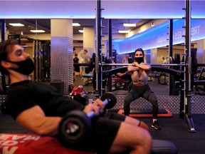 Exercisers in Barcelona wear masks in November after Spain's Catalonia region allowed gyms to reopen. Most regional and national public health officials have sided with the World Health Organization's stance that exercise and masks don’t mix, but some dissenting views are changing the conversation.
