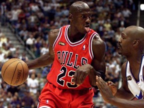 Chicago Bulls guard Michael Jordan of the defending NBA champion Chicago Bulls drives to the hoop against the Utah Jazz'  Brian Russell during Game 2 of the NBA Finals in Salt Lake City, June 5, 1998. Jordan led his team with 37 points as the Bulls won the game 93-88.
