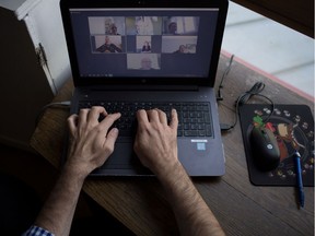 A man takes part in a video conference as he works from home, in Vertou, outside Nantes, France, in May 2020.