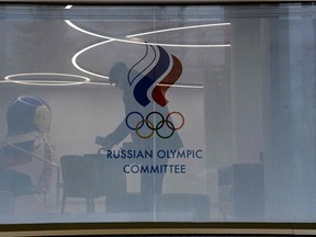 A picture shows the logo of the Russian Olympic Committee (ROC) on the window of its headquarters in Moscow on December 17, 2020, hours before the Court of Arbitration for Sport (CAS) is to deliver its verdict over Russia ban from international sports imposed following allegations of state-sanctioned doping.