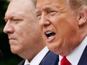 In this file photo taken on May 29, 2020, U.S. President Donald Trump, with Secretary of State Mike Pompeo, holds a press conference in the Rose Garden of the White House in Washington, D.C. Trump on Saturday, Dec. 19, 2020, downplayed a massive cyberattack on U.S. government agencies, declaring it "under control" and undercutting the assessment by his own administration that Russia was to blame. Trump's response came a day after Pompeo said in an interview the attack, which cyber experts say could have far-reaching effects and take months to unravel, was "pretty clearly" Russia's work.