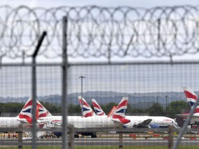 (FILES) In this file photo taken on  1, May 2020 Aircraft grounded due to the COVID-19 pandemic, including planes operated by British Airways, are pictured on the apron at London Gatwick Airport near Crawley, southern England.