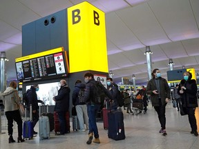 Travellers queue with their luggage in the departures hall at Terminal 2 of Heathrow Airport in west London on December 21, 2020, as a string of countries around the world banned travellers arriving from the UK, due to the rapid spread of a new, more-infectious coronavirus strain.