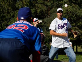 Former Montreal Expos Derek Aucoin, right,  throws a ball with a young fan as he  joins the Expos Nation group for a pitch and catch session in Jarry Park in Montreal on August 17, 2013.