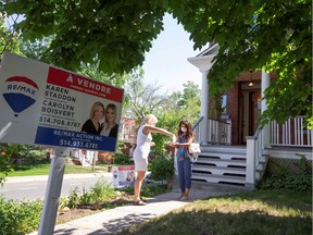 A client has her hands sanitized by a real estate agent at a visit to a house for sale in Montreal in June.
