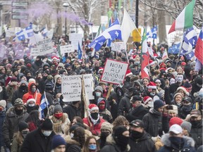People participate in a demonstration in Montreal, Sunday, Dec. 20, 2020, protesting measures implemented by the Quebec government to help stop the spread of COVID-19.