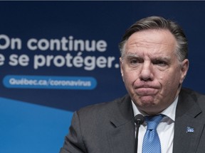 Quebec Premier Francois Legault listens to a question during a news conference in Montreal, on Tuesday, December 22, 2020.