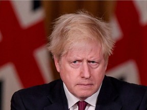 Britain's Prime Minister Boris Johnson during a news conference in response to the continuing situation with the coronavirus disease (COVID-19) pandemic, inside 10 Downing St. in London on Saturday, Dec. 19, 2020.