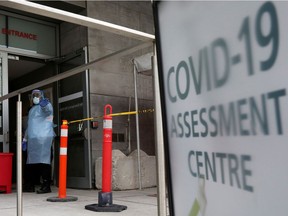 A nurse guides people being tested for coronavirus disease (COVID-19) outside a hospital in Toronto on Dec. 10, 2020.