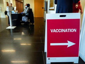 A sign directs health- care workers to a rehearsal for the administration of the Pfizer coronavirus disease (COVID-19) vaccine at Indiana University Health in Indianapolis on Dec.11, 2020.