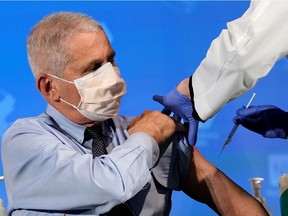 Dr. Anthony Fauci, director of the National Institute of Allergy and Infectious Diseases, prepares to receive his first dose of the new Moderna COVID-19 vaccine at the National Institutes of Health in Bethesda, Md., on Dec. 22, 2020.