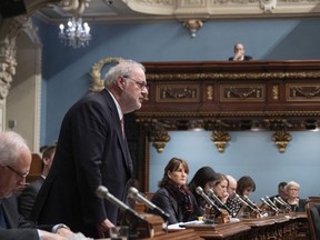 Pierre Arcand, pictured at the legislature in Quebec City in February, has promised to respect the 14-day isolation period required by the federal government for travellers who return from abroad.