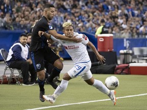CD Olimpia midfielder German Mejia shoves Montreal Impact midfielder Saphir Taider during second half of the first leg of the 2020 CONCACAF Champions League quarter-finals in Montreal on March 10, 2020.