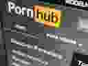 The Pornhub website is shown on a computer screen in Toronto in December, 2020. Pornhub says it has removed all content uploaded by non-verified users. The sex website faced accusations it hosted illegal content. The company, which is owned by Montreal-based MindGeek, says it has suspended all previously uploaded content that was not created by one of its content partners or members of its Model Program.