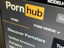 The Pornhub website is shown on a computer screen in Toronto in December 2020. Pornhub says it has removed all content uploaded by unverified users.  The sex website faced accusations of hosting illegal content.  The company, owned by Montreal-based MindGeek, says it has suspended all previously uploaded content that was not created by one of its content partners or members of its Model Program.