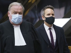 Former radio and television personality Eric Salvail, accompanied by his lawyer Michel Massicotte, arrives at the courthouse to hear the verdict in his sexual assault trial in Montreal on Friday, Dec. 18, 2020.