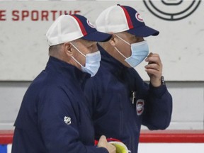 All Canadiens coaches, including head coach Claude Julien (left)and assistant Dominique Ducharme, are wearing masks at training camp because of COVID-19.