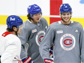 Canadiens centre Jesperi Kotkaniemi (right) flashes smile while chatting with linemates Jonathan Drouin (left) and Tyler Toffoli during training-camp practice at the Bell Sports Complex in Brossard.