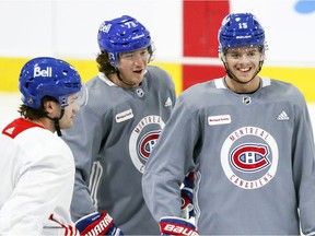 Newly-acquired forward Tyler Toffoli, centre, speaks with Jonathan Drouin, left, and Jesperi Kotkaniemi during Montreal Canadiens training-camp practice at the Bell Sports Complex in Brossard on Jan. 4, 2021.