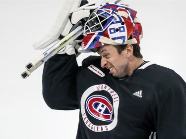 Jake Allen pulls his mask down over his face during Montreal Canadiens training camp practice at the Bell Sports Complex in Brossard on Tuesday Jan. 5, 2021.