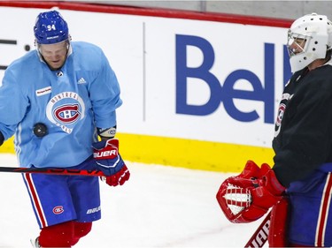 Carey Price, right, tosses a puck at Corey Perry during Perry's first appearance at Montreal Canadiens training camp at the Bell Sports Complex in Brossard on Tuesday Jan. 5, 2021.