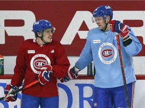 Brendan Gallagher, left, speaks with Corey Perry during Perry's first Montreal Canadiens training-camp practice at the Bell Sports Complex in Brossard on Jan. 5, 2021.