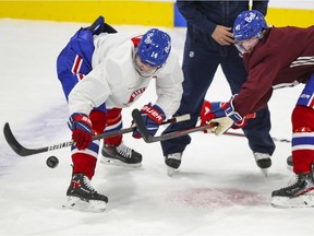 Nick Suzuki, left, and Paul Byron practise faceoffs during Montreal Canadiens training-camp practice at the Bell Sports Complex in Brossard on Jan. 5, 2021.