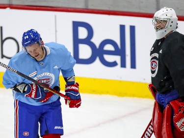 Corey Perry grimaces after Carey Price, right, threw a puck at him during Perry's first Montreal Canadiens training camp practice at the Bell Sports Complex in Brossard on Tuesday Jan. 5, 2021.