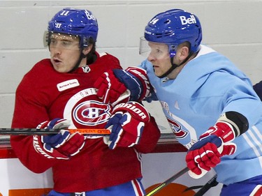 Corey Perry, right, rides Brendan Gallagher into the boards during Montreal Canadiens training camp practice at the Bell Sports Complex in Brossard on Wednesday, January 6, 2021.