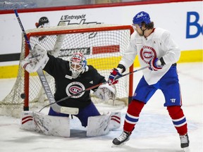 Josh Anderson deflects a puck in front of goalie Michael McNiven during Canadiens training-camp practice at the Bell Sports Complex in Brossard in January 2021.