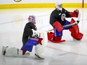 Jake Allen, left, and Carey Price stretch prior to Montreal Canadiens training-camp practice at the Bell Sports Complex in Brossard on Jan. 6, 2021.