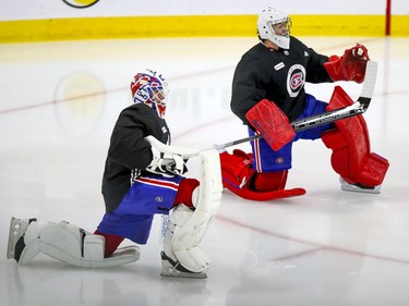 Jake Allen, left, and Carey Price stretch prior to Montreal Canadiens training camp practice at the Bell Sports Complex in Brossard on Wednesday, January 6, 2021.