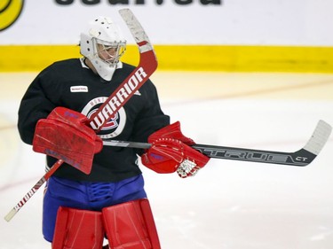 Carey Price carries a couple of goalie sticks during Montreal Canadiens training camp practice at the Bell Sports Complex in Brossard on Wednesday, January 6, 2021.